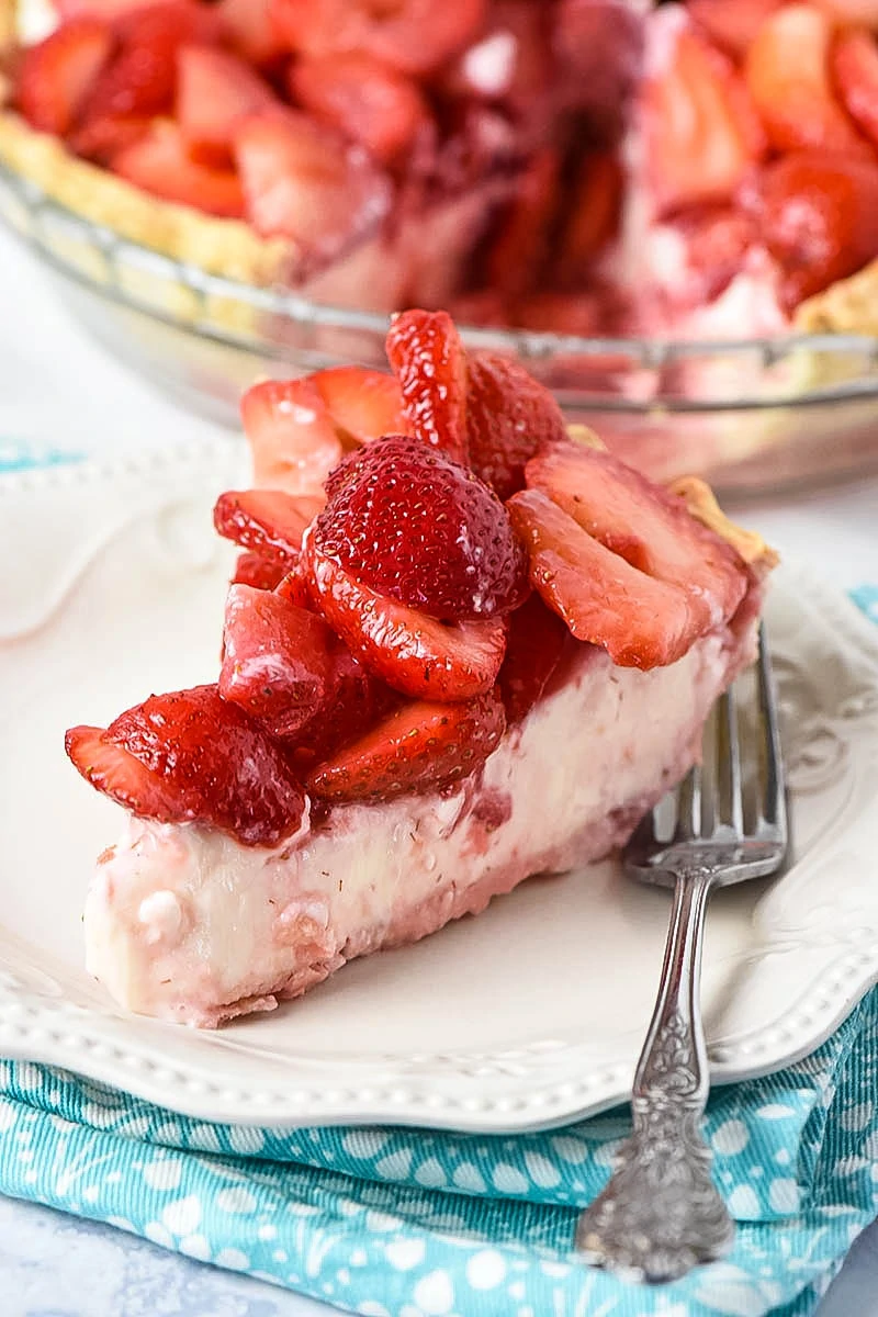 slice of strawberry cream cheese pie on white plate with fork