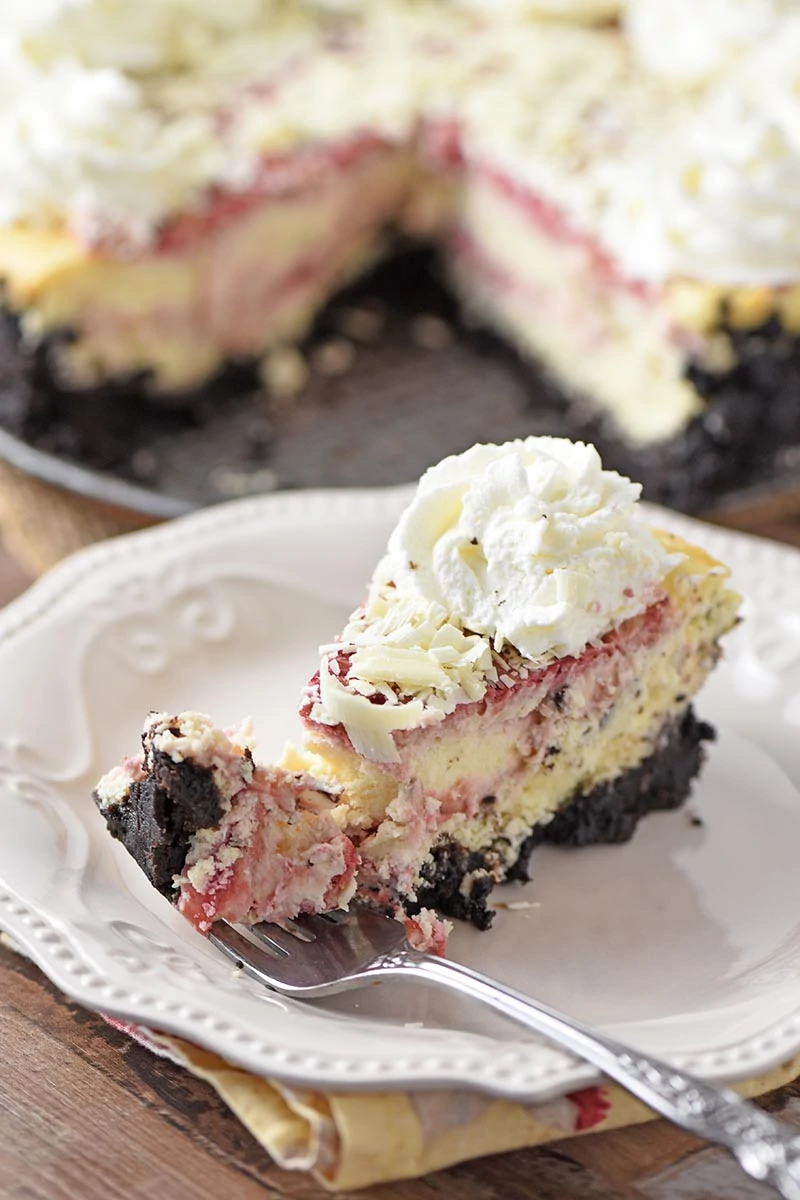 bite of raspberry swirl cheesecake on fork
