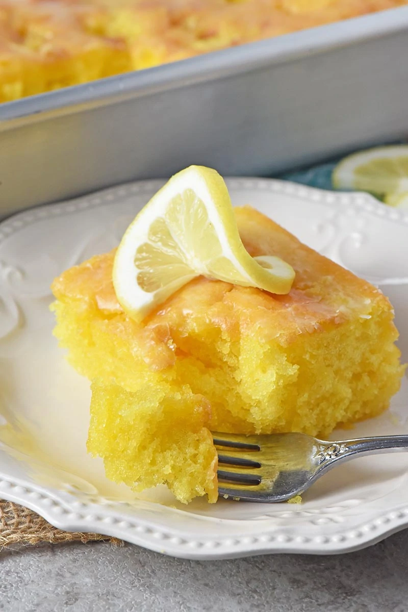 bite of easy lemon cake with glaze on fork