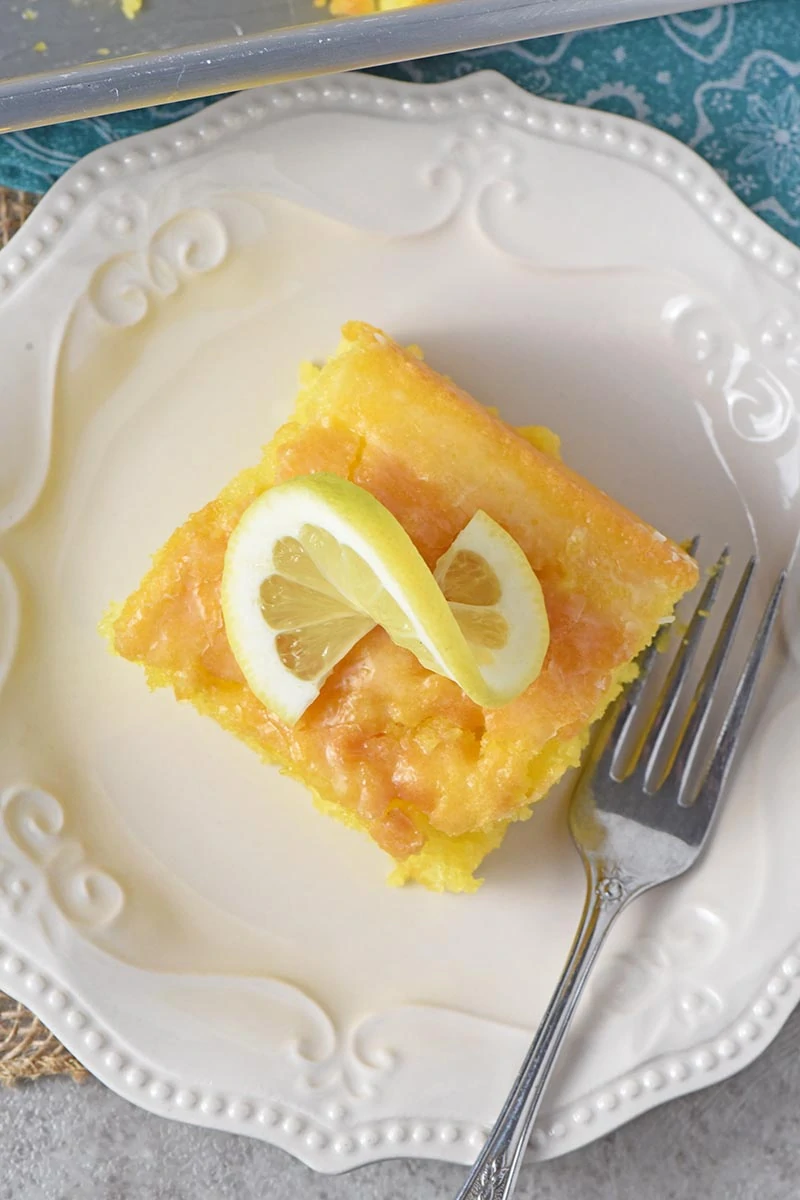 sliced lemon pudding cake on white plate, made with easy lemon cake recipe