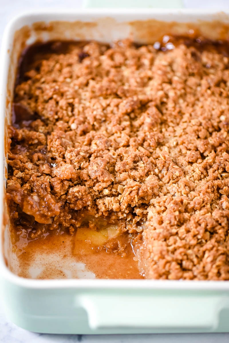 best gluten-free apple crisp in mint green baking dish, baked and scooped