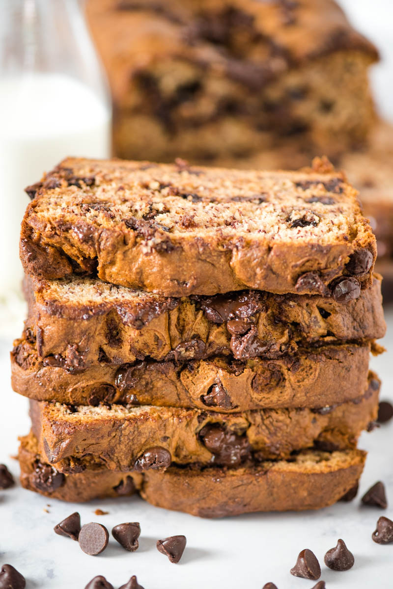 stack of banana bread with chocolate chips on white marble countertop 