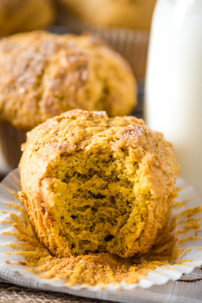 easy pumpkin spice muffins, one with bite taken out in white cupcake liner