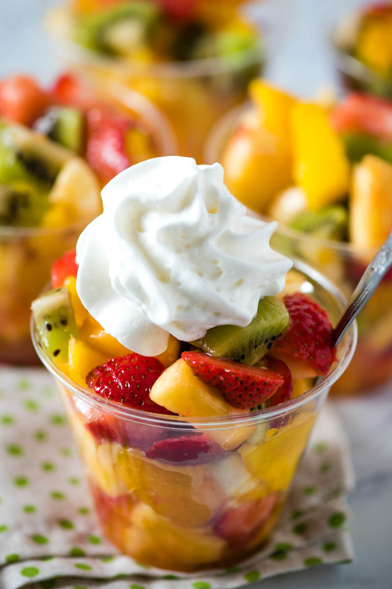 homemade tropical fruit cups with dollop of whipped cream on top