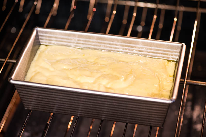 gluten-free pound cake batter in metal cake pan on oven rack