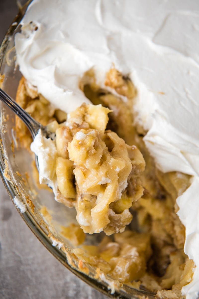 spoonful of homemade banana pudding over casserole dish