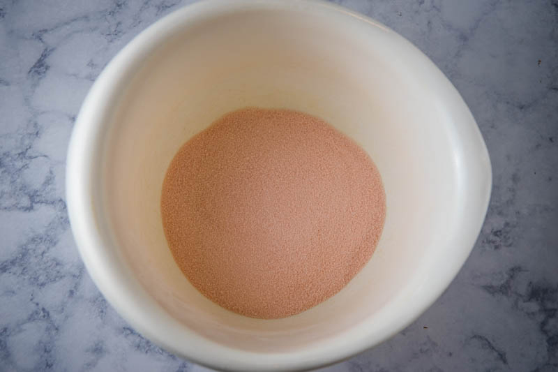 orange Jello mix in white mixing bowl