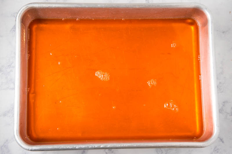 liquid orange Jello for Jello Jigglers in metal cake pan
