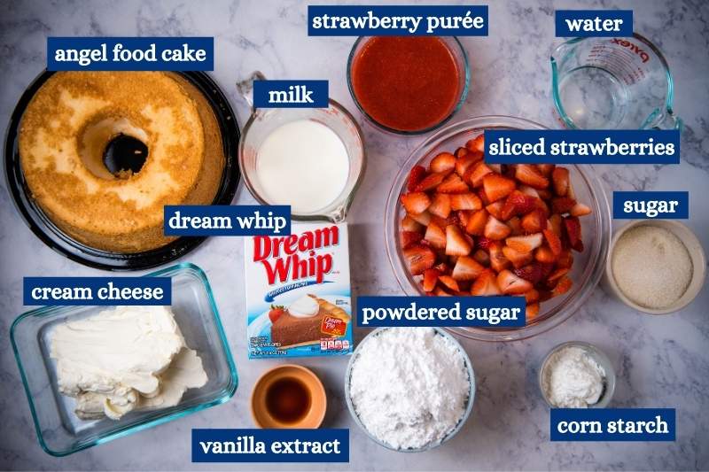 ingredients for strawberry angel delight dessert on white marble countertop