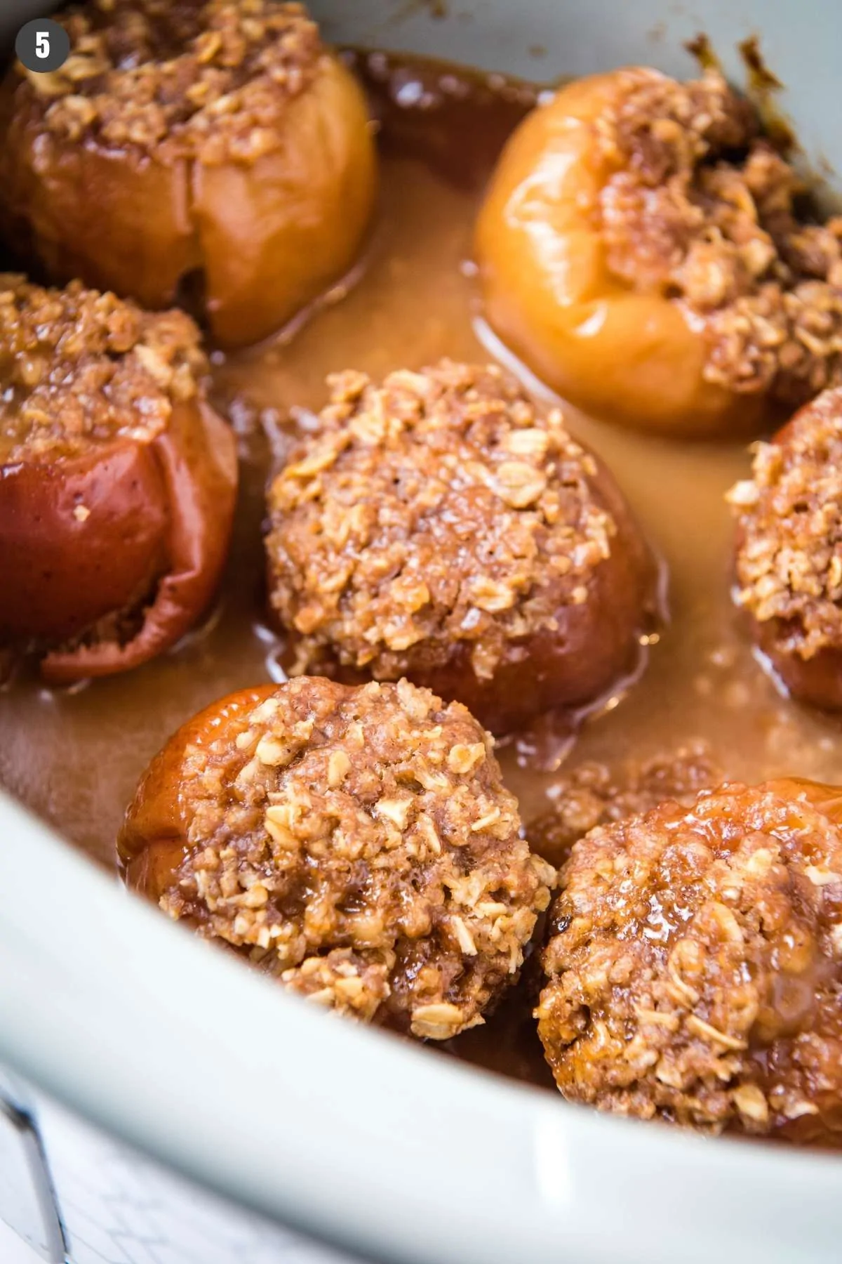 baked apples in a gray Crock Pot