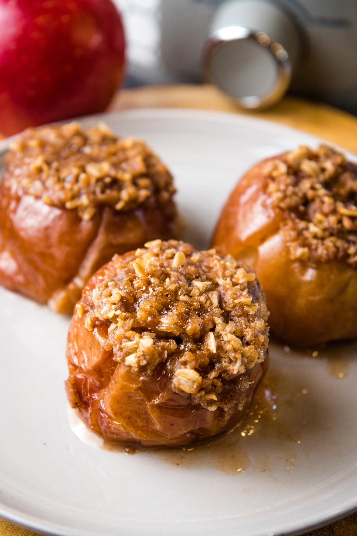 Crock Pot baked apples stuffed with oats on gray plate