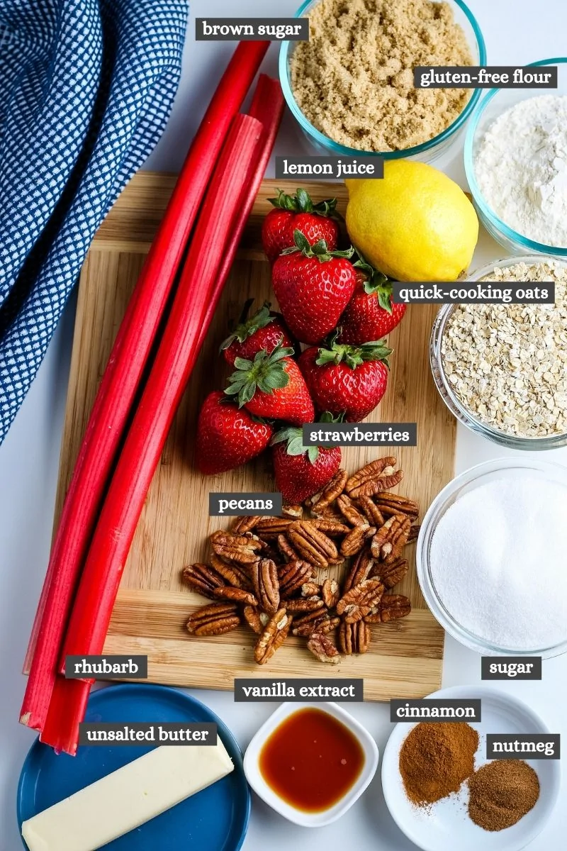 ingredients for gluten-free strawberry rhubarb crumble on wood cutting board