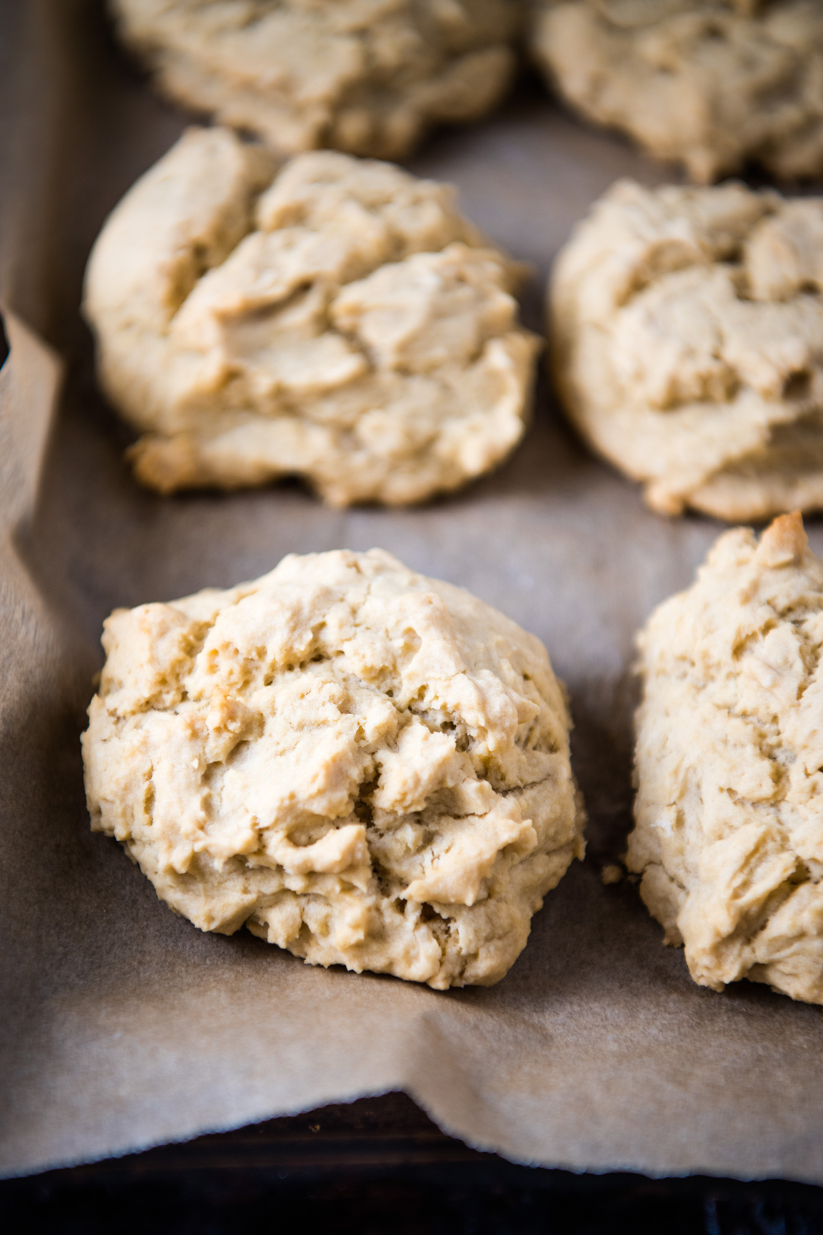 baked gluten-free biscuits dropped onto parchment paper covered baking sheet