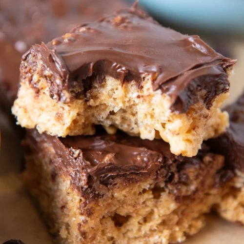 chocolate peanut butter Rice Krispie treat squares stacked up on top of each other