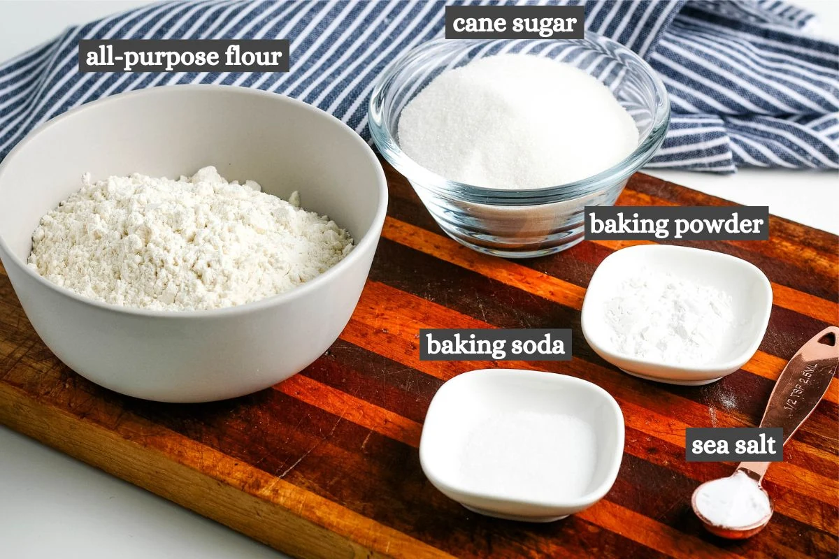 homemade cake mix ingredients lined out on large wooden cutting board