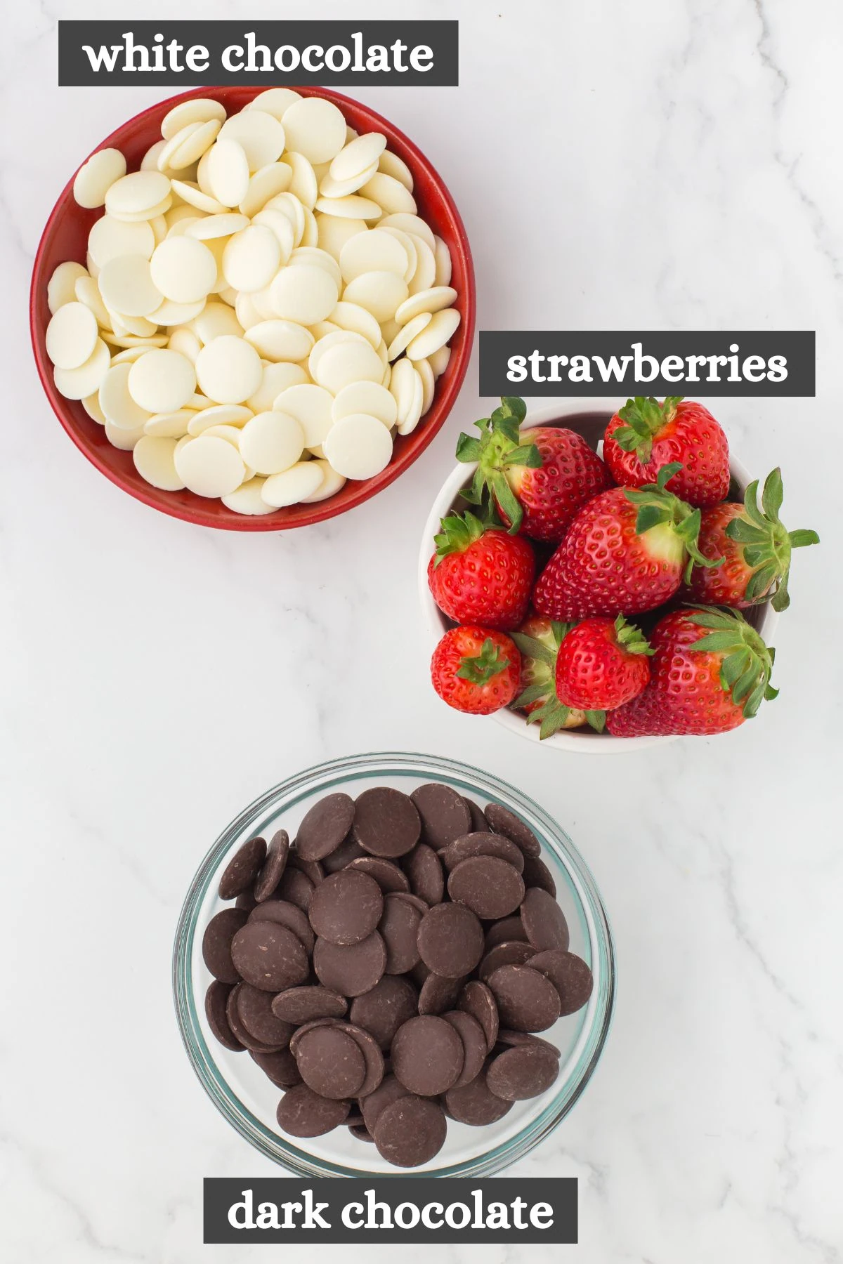 chocolate covered strawberries recipe ingredients lined out on a white marbled countertop