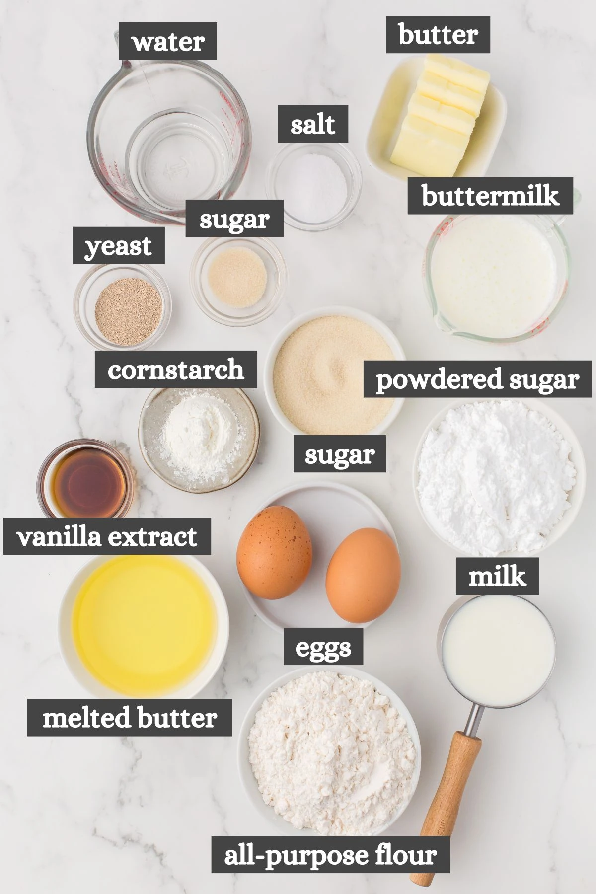 glazed donuts recipe ingredients lined out on a white marbled countertop