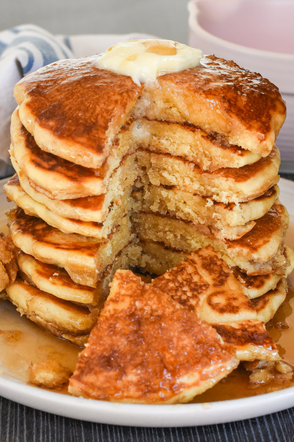 stack of pancakes with a wedge sliced out to show the tender crumb and fluffy texture